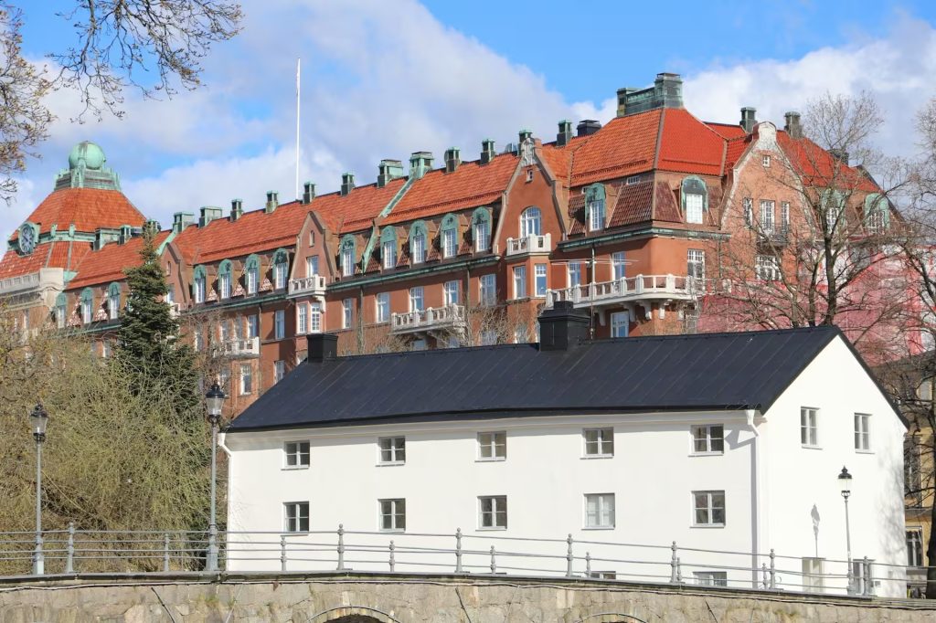 Vitt hus med svart plåttak i stadsmiljö